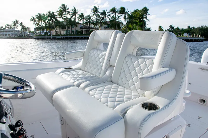 Slide: The Image of Luxurious white leather seats on a 2021 Intrepid boat, with waterfront view. - 26