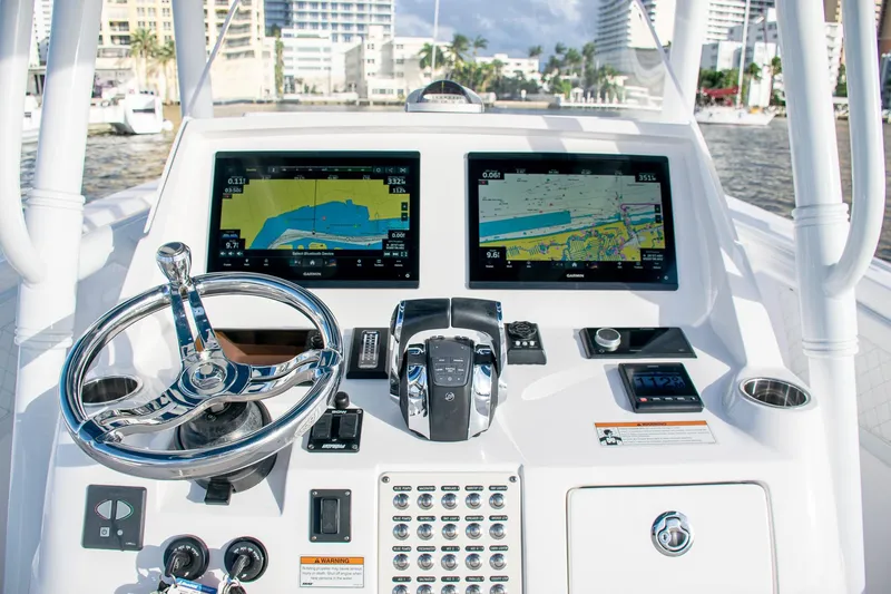 Slide: The Image of Intrepid 2021 boat dashboard with dual Garmin navigation screens and steering wheel. - 29