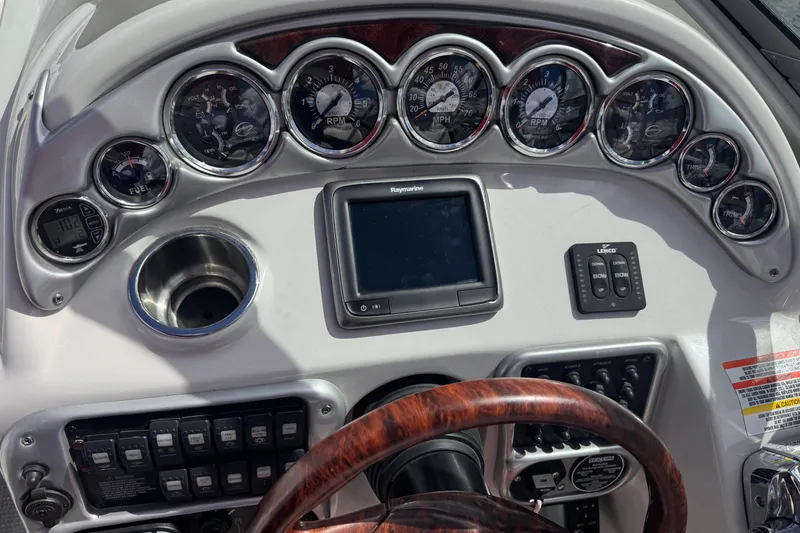 Slide: The Image of Dashboard of a 2008 Crownline 320 LS boat with gauges and controls. - 10