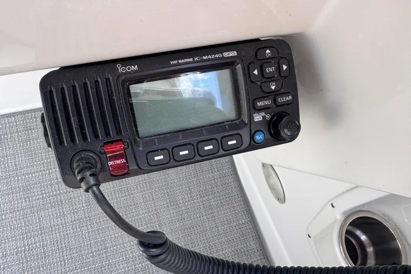 Slide: The Image of VHF marine radio on 2008 Crownline 320 LS boat dashboard, featuring distress button. - 16