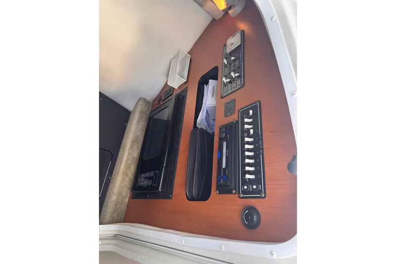 Slide: The Image of Control panel of a 2008 Crownline 320 LS boat with switches and a microwave. - 17