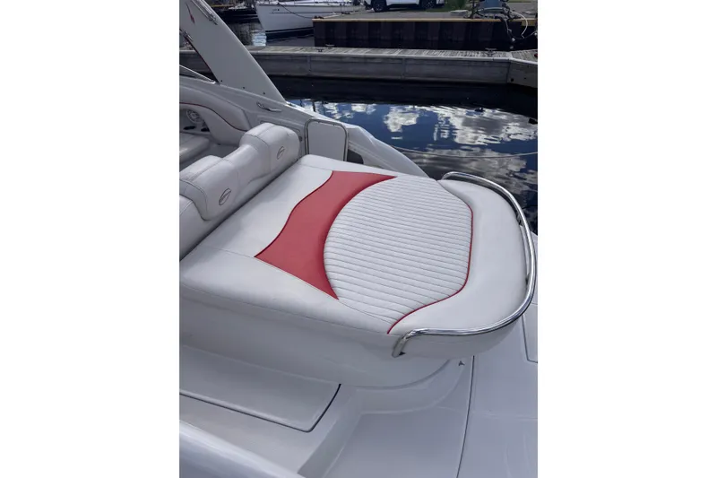 Slide: The Image of 2008 Crownline 320 LS boat with white and red cushioned seating at a marina. - 19