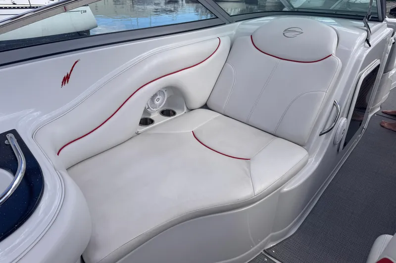 Slide: The Image of 2008 Crownline 320 LS boat interior with white seating and red accents. - 20