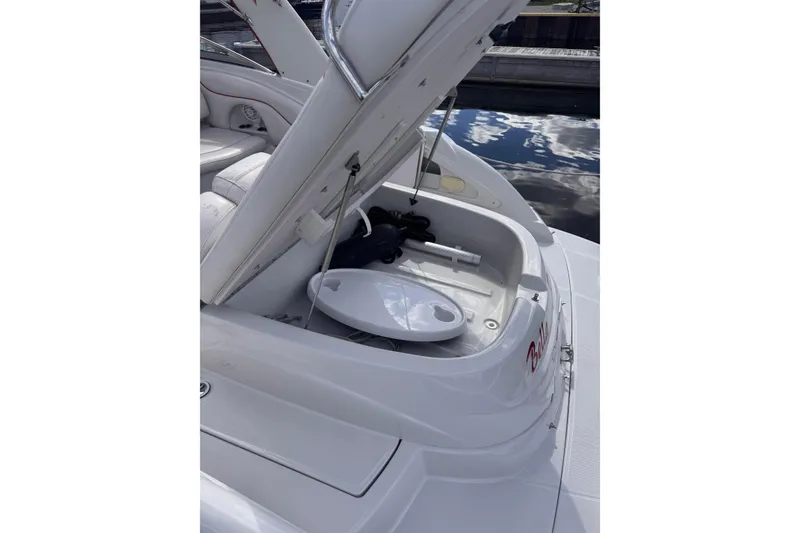 Slide: The Image of Open storage compartment on a 2008 Crownline 320 LS boat, dockside view. - 21