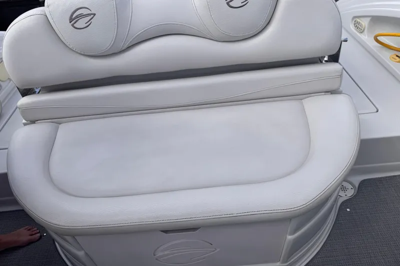 Slide: The Image of Crownline 320 LS 2008 boat seat with white upholstery and logo detailing. - 23