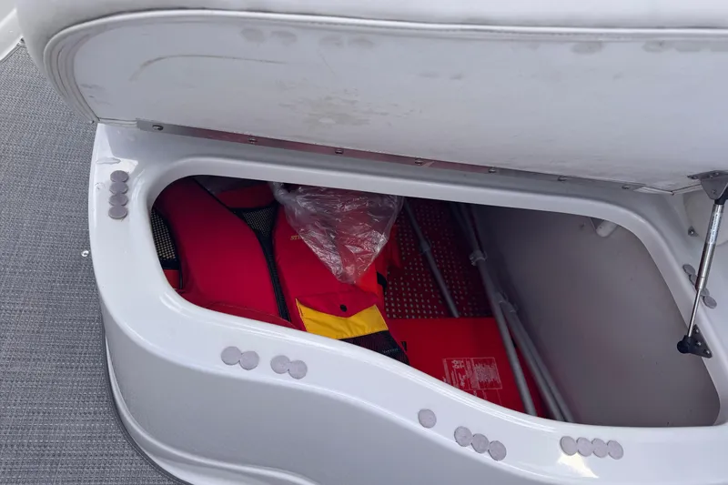 Slide: The Image of Storage compartment in a 2008 Crownline 320 LS boat with life jackets inside. - 24