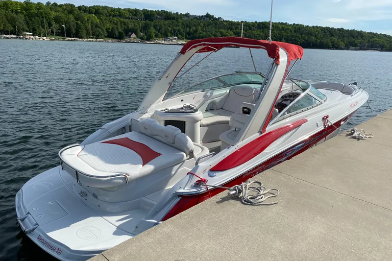 Slide: The Image of 2008 Crownline 320 LS boat docked by a scenic lakeside with lush greenery. - 5