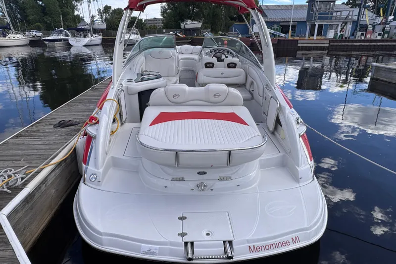 Slide: The Image of 2008 Crownline 320 LS boat docked at marina, featuring spacious seating and sleek design. - 7