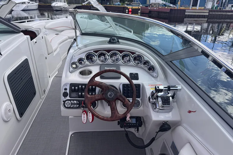Slide: The Image of 2008 Crownline 320 LS boat dashboard with steering wheel and control panel. - 9