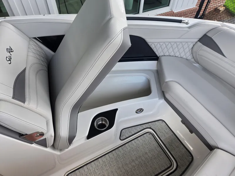 Slide: The Image of The 2027 Sea Ray SLX 280 Outboard features luxurious padded seating with storage underneath. - 17