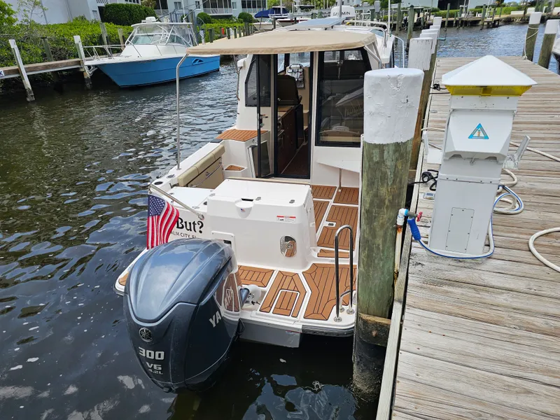 Slide: The Image of A 2025 Ranger Tugs R-27 is docked. It features a Yamaha outboard motor. - 12