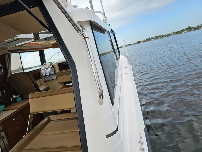 Slide: The Image of A 2025 Ranger Tugs R-27 on calm water, showing the interior view. - 36
