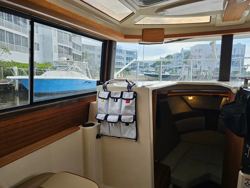 Slide: The Image of Interior of a 2025 Ranger Tugs R-27 with a cozy cabin and windows. - 17