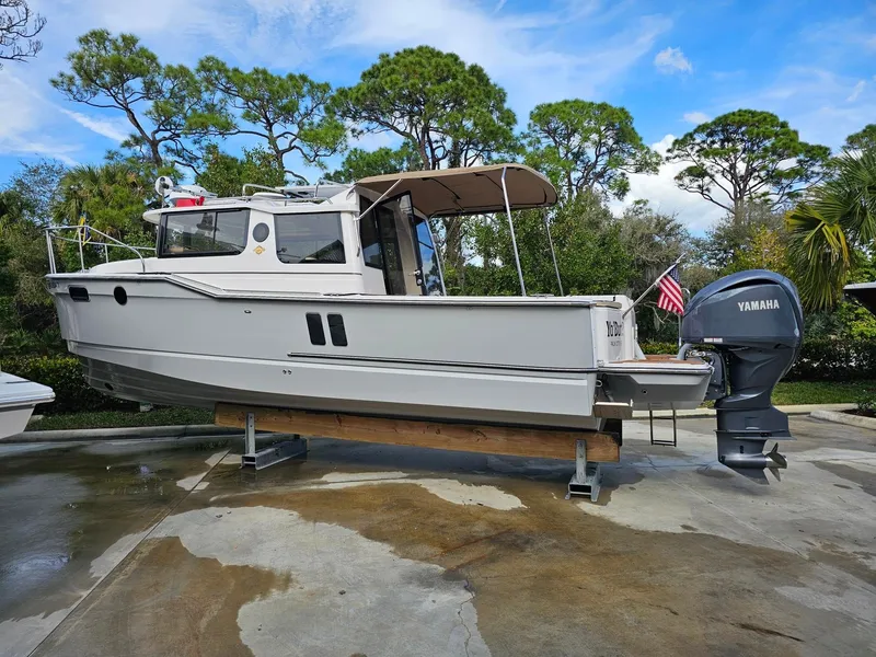 Slide: The Image of A 2025 Ranger Tugs R-27 on a stand, featuring a Yamaha outboard motor. - 37