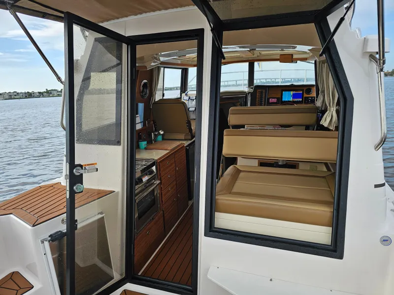 Slide: The Image of The image shows the interior of a Ranger Tugs R-27 boat with sleek seating and modern amenities. - 34