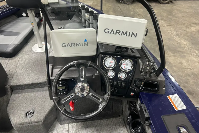 Slide: The Image of 2024 Tracker Targa V-18 Combo boat dashboard with Garmin displays and steering wheel. - 15