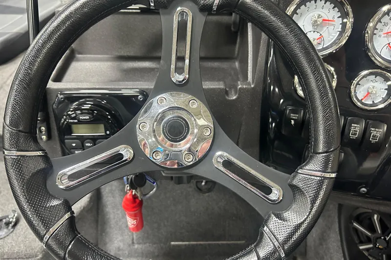 Slide: The Image of Steering wheel and dashboard of 2024 Tracker Targa V-18 Combo boat. - 16