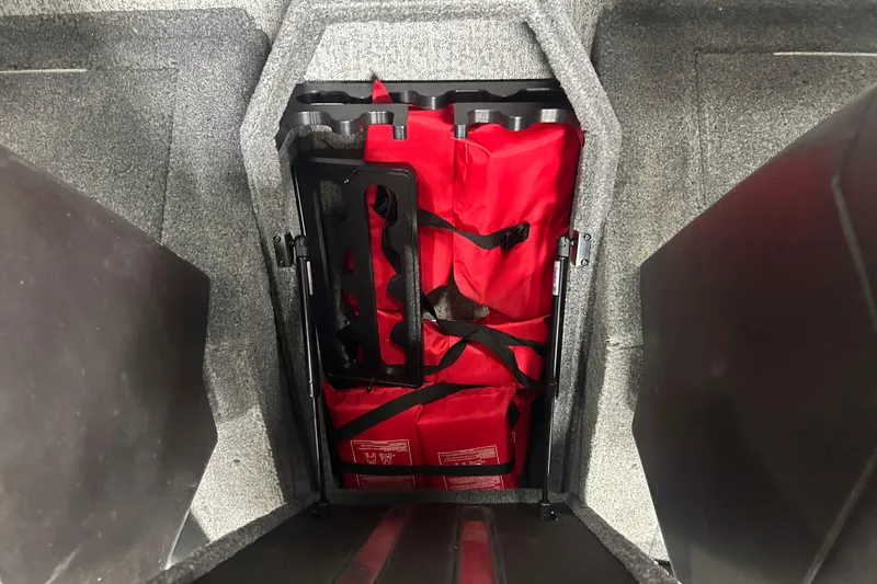 Slide: The Image of Storage compartment with red life jackets in 2024 Tracker Targa V-18 Combo boat. - 21