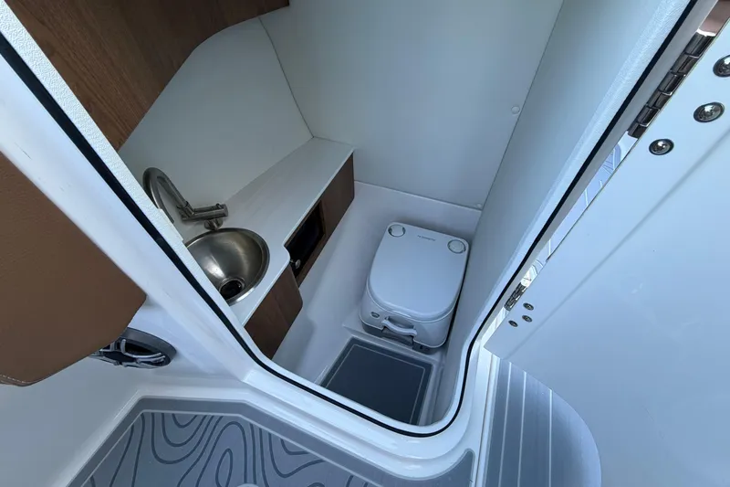 Slide: The Image of Compact bathroom in 2027 Regal LS6 boat with sink and portable toilet. - 15