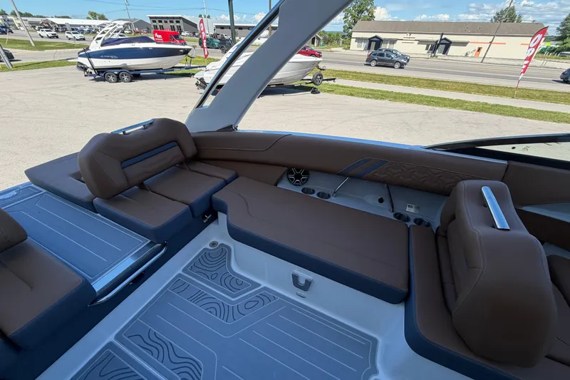 Slide: The Image of 2027 Regal LS6 boat interior with brown seating and modern design elements. - 16