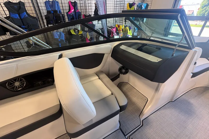Slide: The Image of Interior of a 2027 Regal 2000 ES boat with white seating and dashboard. - 12