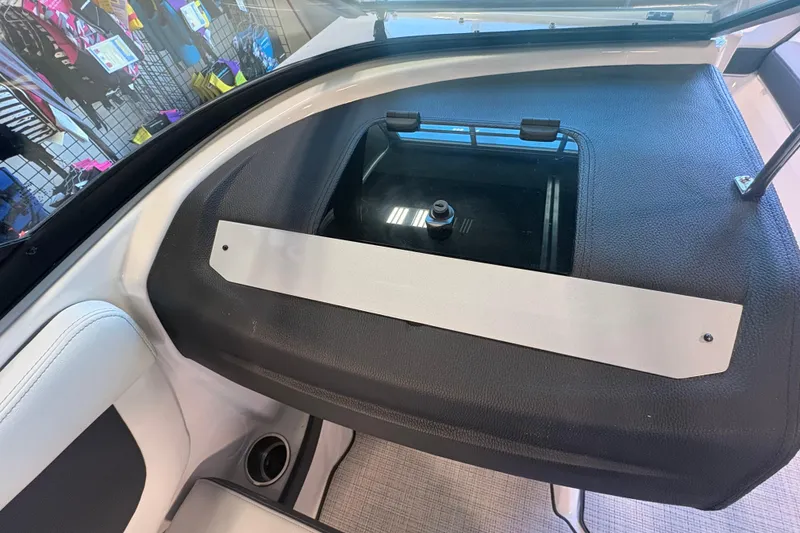 Slide: The Image of Interior view of a 2027 Regal 2000 ES boat, showcasing storage compartment and seating area. - 13