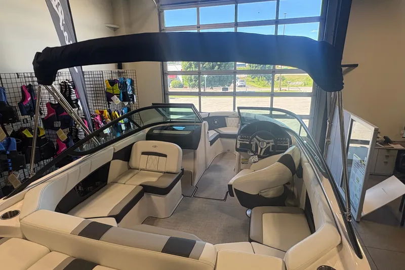 Slide: The Image of 2027 Regal 2000 ES boat interior with seating and steering wheel in showroom. - 5