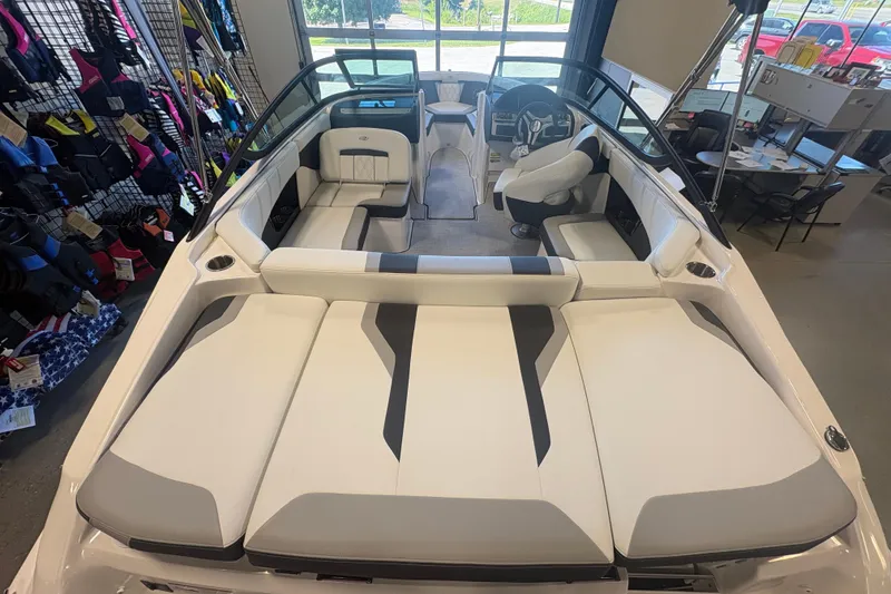 Slide: The Image of 2027 Regal 2000 ES boat interior with white and gray seating in showroom. - 6