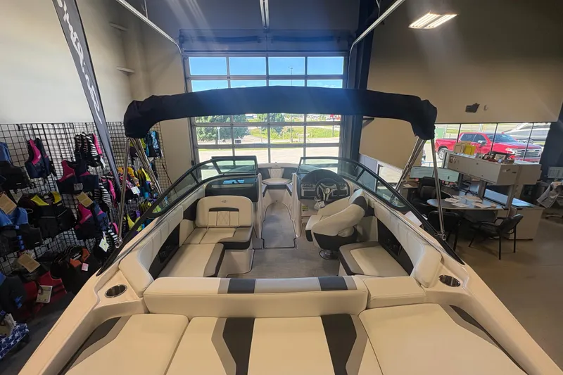 Slide: The Image of 2027 Regal 2000 ES boat interior in showroom, featuring sleek seating and modern design. - 7