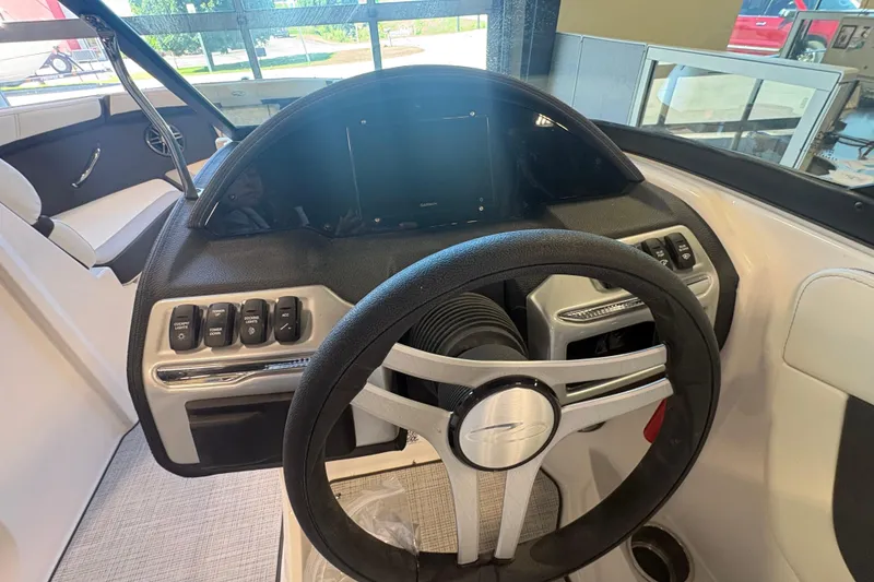 Slide: The Image of 2027 Regal 2000 ES boat dashboard with steering wheel and control panel. - 14