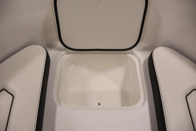 Slide: The Image of 2021 Stingray 172 SC boat interior storage compartment with cushioned seating. - 14