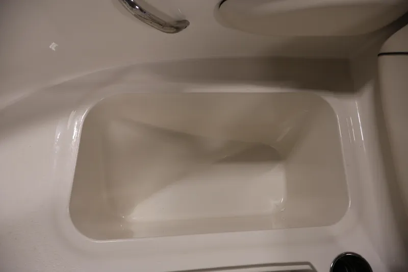 Slide: The Image of Interior view of a 2021 Stingray 172 SC boat compartment with a sleek, white finish. - 16