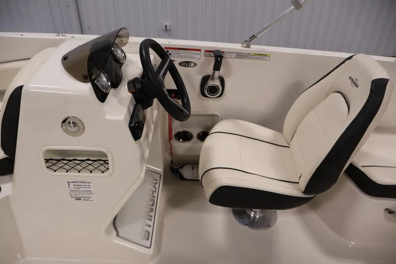 Slide: The Image of 2021 Stingray 172 SC boat interior with steering console and cushioned seat. - 17