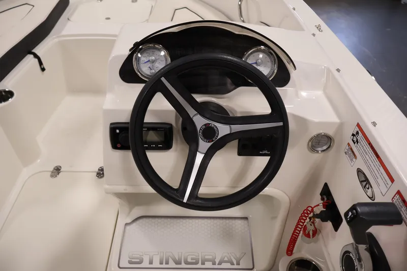 Slide: The Image of 2021 Stingray 172 SC boat dashboard with steering wheel and gauges. - 18