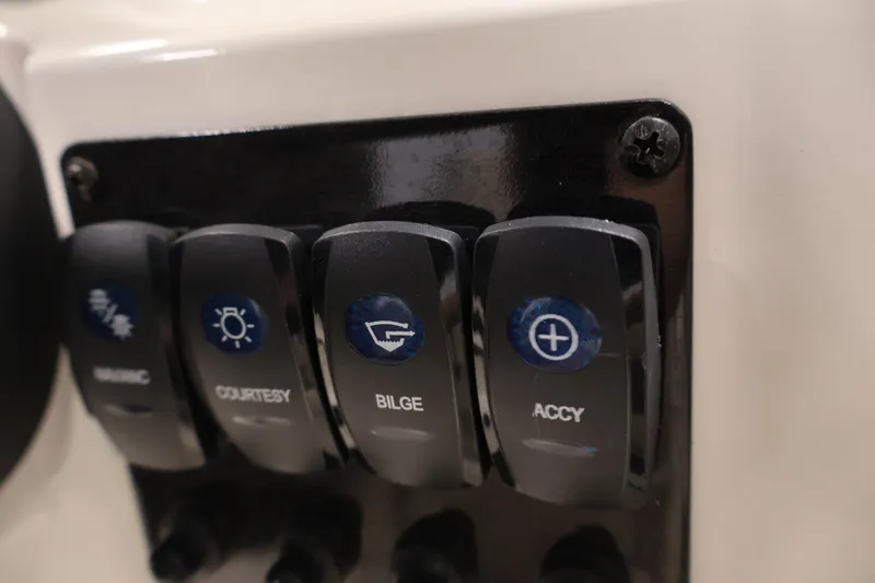 Slide: The Image of Control panel switches on a 2021 Stingray 172 SC boat. - 23