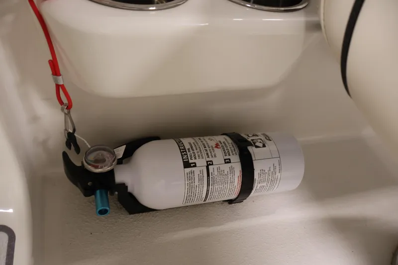 Slide: The Image of Fire extinguisher mounted in 2021 Stingray 172 SC boat interior for safety. - 25