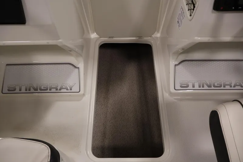 Slide: The Image of Interior view of a 2021 Stingray 172 SC boat, featuring branded flooring. - 31
