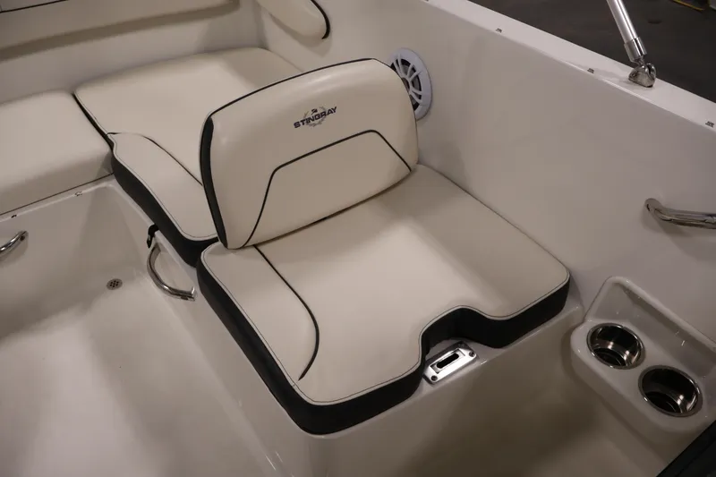 Slide: The Image of 2021 Stingray 172 SC boat interior with cushioned seating and cup holders. - 32