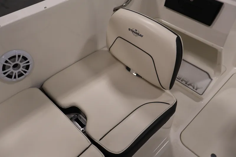 Slide: The Image of 2021 Stingray 172 SC boat interior with beige seating and speaker detail. - 33