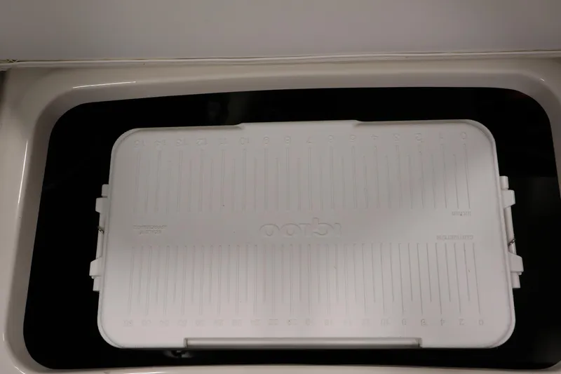 Slide: The Image of White cooler inside a 2021 Stingray 172 SC boat compartment. - 35