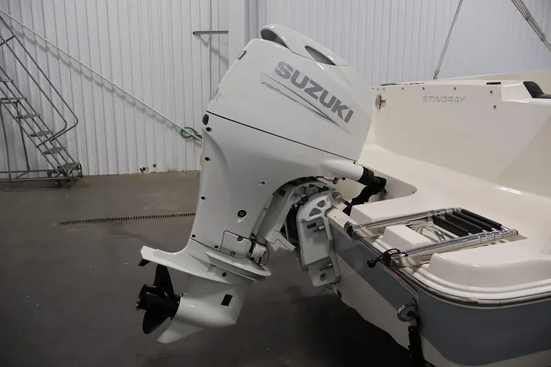 Slide: The Image of 2021 Stingray 172 SC boat with Suzuki outboard motor in a garage setting. - 39