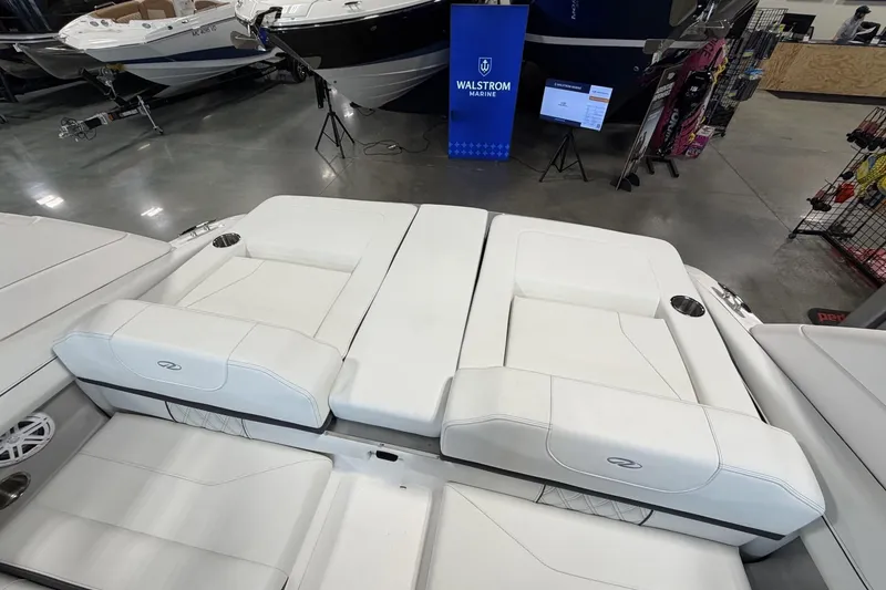 Slide: The Image of 2027 Regal LS2 boat interior with white seating at Walstrom Marine showroom. - 15