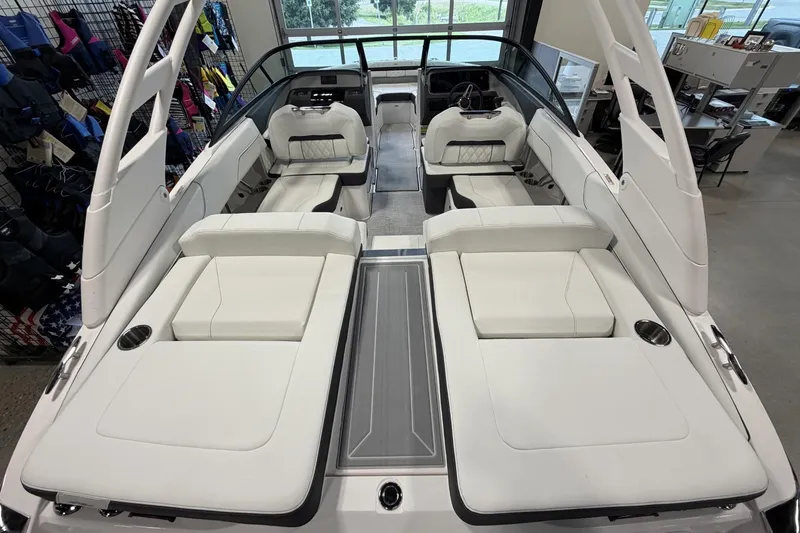 Slide: The Image of 2027 Regal LS2 boat interior with white seating and modern design in showroom. - 8