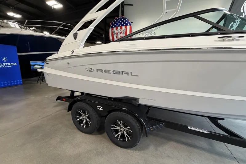 Slide: The Image of 2027 Regal LS2 boat on trailer in showroom, featuring sleek design and modern aesthetics. - 4
