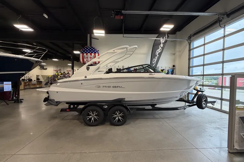 Slide: The Image of 2027 Regal LS2 boat displayed indoors on a trailer, showcasing sleek design and modern features. - 17