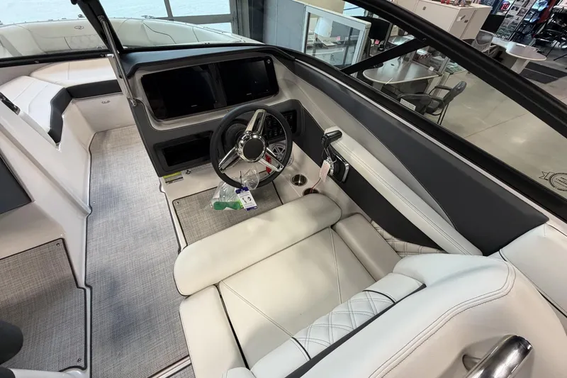 Slide: The Image of Interior of a 2027 Regal LS2 boat featuring a sleek steering wheel and modern dashboard. - 16