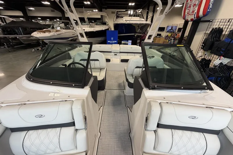 Slide: The Image of 2027 Regal LS2 boat interior with white seating, displayed in a showroom. - 10