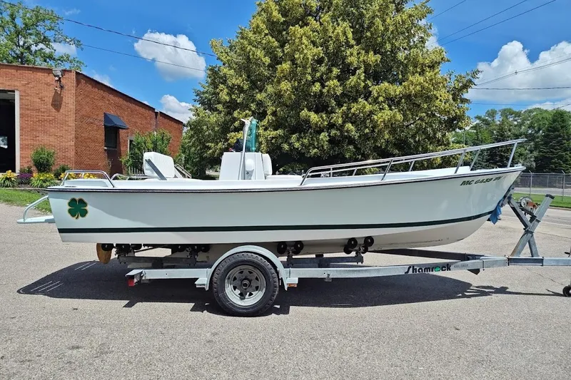 Slide: The Image of 1975 Shamrock 200 Open boat on trailer, parked outdoors near brick building. - 3