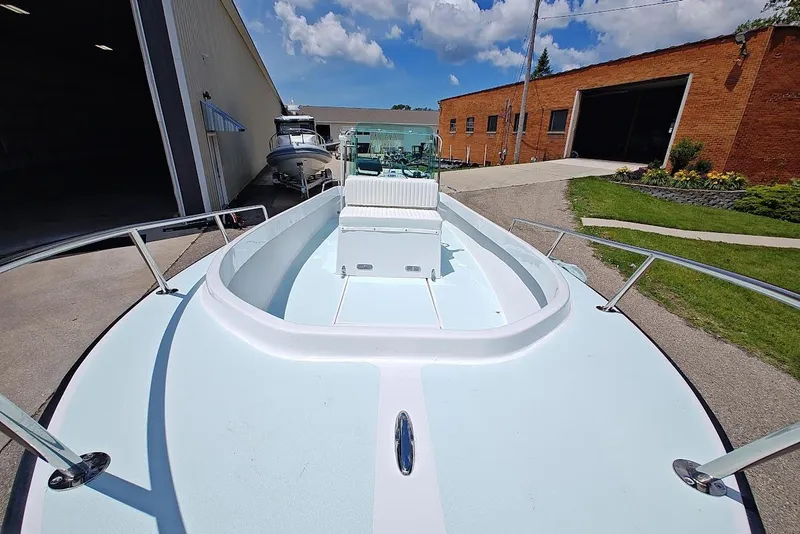 Slide: The Image of 1975 Shamrock 200 Open boat docked outside, showcasing spacious deck and sleek design. - 6