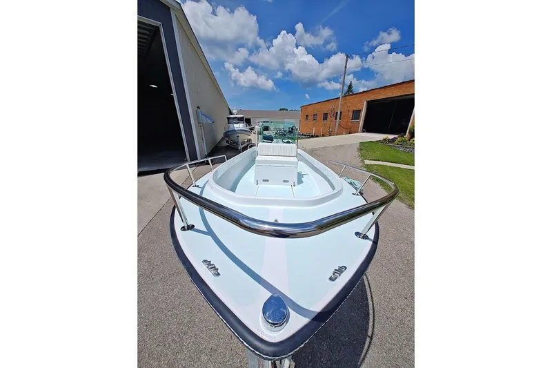 Slide: The Image of 1975 Shamrock 200 Open boat, docked outdoors, under a clear blue sky. - 7